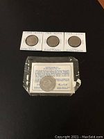 Top view of three Golden Jubilee coins in protective holders labeled 1952-2002 Golden Jubilee and one Silver Jubilee coin or medallion in plastic case with descriptive card.