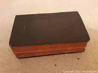 Thick black cover of the prayer book, showing wear and minor scuffs consistent with age.