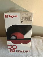 Front of the box showing the Biogenik brand, product name Duo Case Plus, and a black and red Nintendo Switch case resembling a Pokeball design.