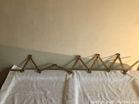 Image showing the ruler partially extended in accordion fashion against a wall.