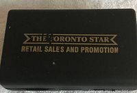 Closed black vintage box with gold lettering on lid: 'The Toronto Star Retail Sales and Promotion'.