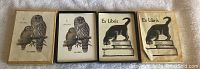 Photo of four book plate sheets featuring two owl designs and two cat designs labeled 'Ex Libris'.