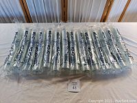 Sealed bundles of Solo 3.5 oz clear plastic beverage cups stacked and displayed on a table.