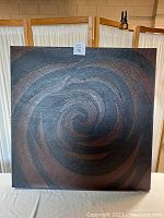 Front view of the abstract spiral art on canvas, showing detailed textured pattern and color composition.