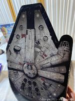Top view of large Millennium Falcon tin container, detailed printed design, shows wear