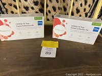 Front view of two unopened EverlyWell COVID-19 Test Home Collection Kit boxes with FDA approval logo visible.