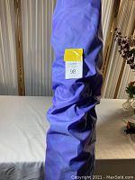 Purple protective storage bag for windsurf sail, folded.