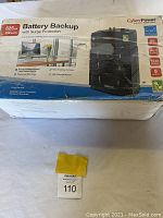 Box front showing product specifications and picture of battery backup including power ratings of 825 VA and 450 Watts and features of surge protection.