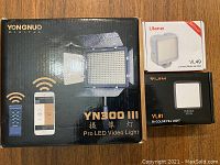 Box of Yongnuo YN300 III Pro LED Video Light along with two smaller Ulanzi LED lights, VL49 and VL81 models with packaging