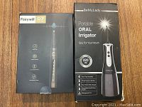 Boxes of Fairywill D7 electric toothbrush and BeMyLady oral irrigator showing brand and main features.