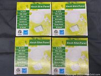 Four boxed 4-inch slim panel LED lights arranged in a grid on a black surface.