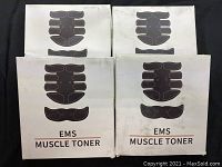 Four EMS Muscle Toner boxes showing front design with device outlines and labels