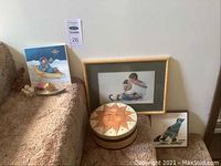 'Tender Moment' framed painting and other items arranged on floor and couch, showing overall lot