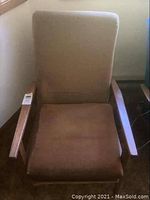 Front view of wood frame chair with brown fabric cushions showing wear