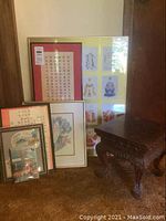 Wooden stool and background framed prints visible