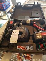 Cordless drill in plastic carrying case with battery and bit set.
