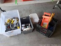 Overview of lot showing three plastic containers filled with items described