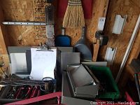 Overall lot: hand tools, trays, blanks and green bin of brackets on red cart