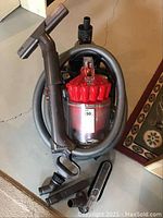 Full view of Dyson vacuum and scattered accessories