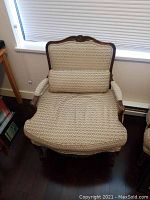 Full view of Bergere armchair showing upholstery and wood frame