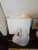 Foldio foldable white photography lightbox studio, folded flat with logo visible.