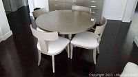 Full view of round table and four chairs in room