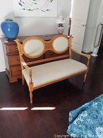 Full front view of pearwood bench showing frame, seat, and backrest upholstery