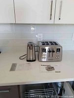 Wide view of both appliances with instruction booklets on counter