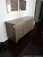 Full view of sideboard under wall art in room