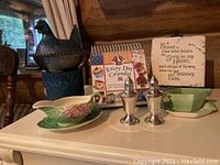Overall photo showing all items: cold dip dish, calendar, sign, salt and pepper shakers, and ceramic chicken container