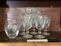 Photo of five crystal glasses and one small round glass vase with sticker showing handmade in Czechoslovakia.