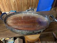 Full view of the large oval tray showing metal frame and wood base