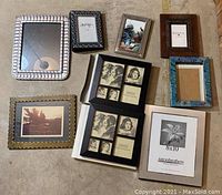 Overview photo showing various picture frames and the small photo album arranged on floor.