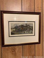 Full view of one framed print showing the entire artwork, mat, and frame with wood panel background