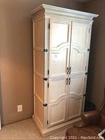 Front view of a tall cream-colored cabinet with four doors, showcasing its solid construction and classic design.