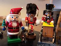 Front view of all three nutcrackers together on a table