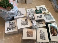 Eleven boxed Dept. 56 Heritage Village houses, light strings, and small accessories laid on a tile floor.