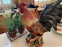 Front and side views of large ceramic Fitz and Floyd rooster figurine showing detailed realistic painting and glossy finish