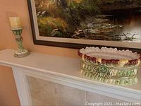 Wide view showing large Fitz and Floyd ceramic planter and candle holder on mantle.