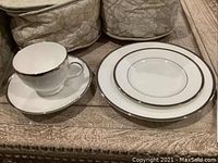 Cups with saucers and plates displayed
