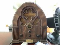 Front view of Philco-Ford Corp Special Edition wooden cathedral-style radio with ornate grille and three control knobs.
