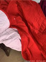 Photo of red quilted side of the king size bedspread showing diamond pattern and fabric texture.