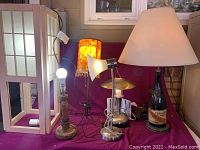 Six lamps on a red surface showing general overall condition and details