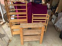 Shows the three wooden shelves positioned next to each other: small unpainted shelf, small folding shelf, and taller folding shelf