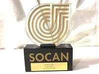 Front view of trophy showing gold geometric acrylic design and black base with gold engraved plaque.