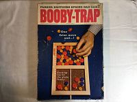 Front view of original box with title and graphic of hand moving game piece, text and branding visible.