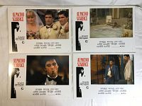 Four vintage Scarface movie poster cards laid out together on white fabric background showing different scenes from the movie.
