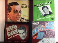 Four album sleeves of antique 78 rpm vinyl record sets featuring Glenn Miller, Danny Kaye, Artie Shaw, and Gems of Jazz Vol 2, 10 inch size.