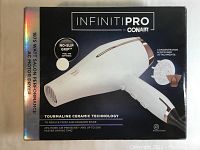 Box front of Conair Infiniti Pro 1875W hair dryer showing product image and key features.