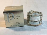 Photo of Cle De Peau Beaute Intensive Eye Contour Cream 2mL box and jar showing product packaging and label.